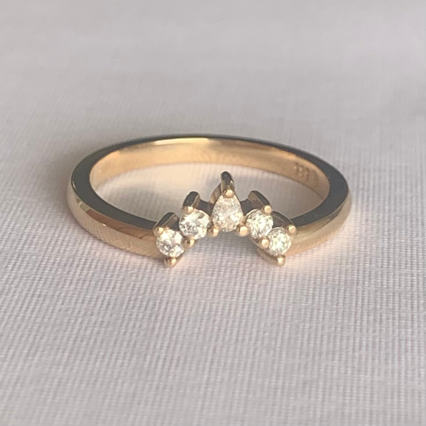 Cara Diamond Arch Band  Band width 2mm  Finger Size O  Complimentary First Size  14ct Yellow Gold  The Diamonds are Colour F clarity VS featuring four 2mm round brilliant cuts and one 3 x 2mm pear cut diamond.  Made with recycled metal in Sydney   Ethically sourced Gemstones